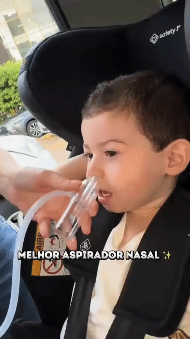 Caregiver demonstrating the manual nasal aspirator